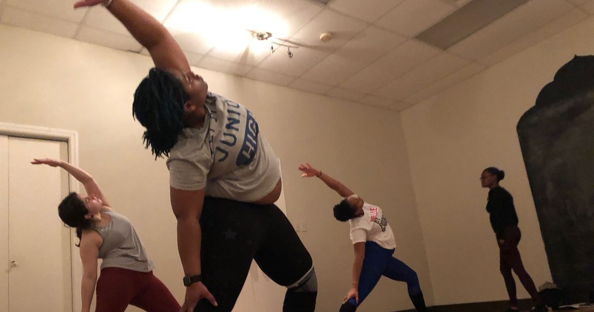 Students in a standing yoga pose during an advanced yoga teacher training session