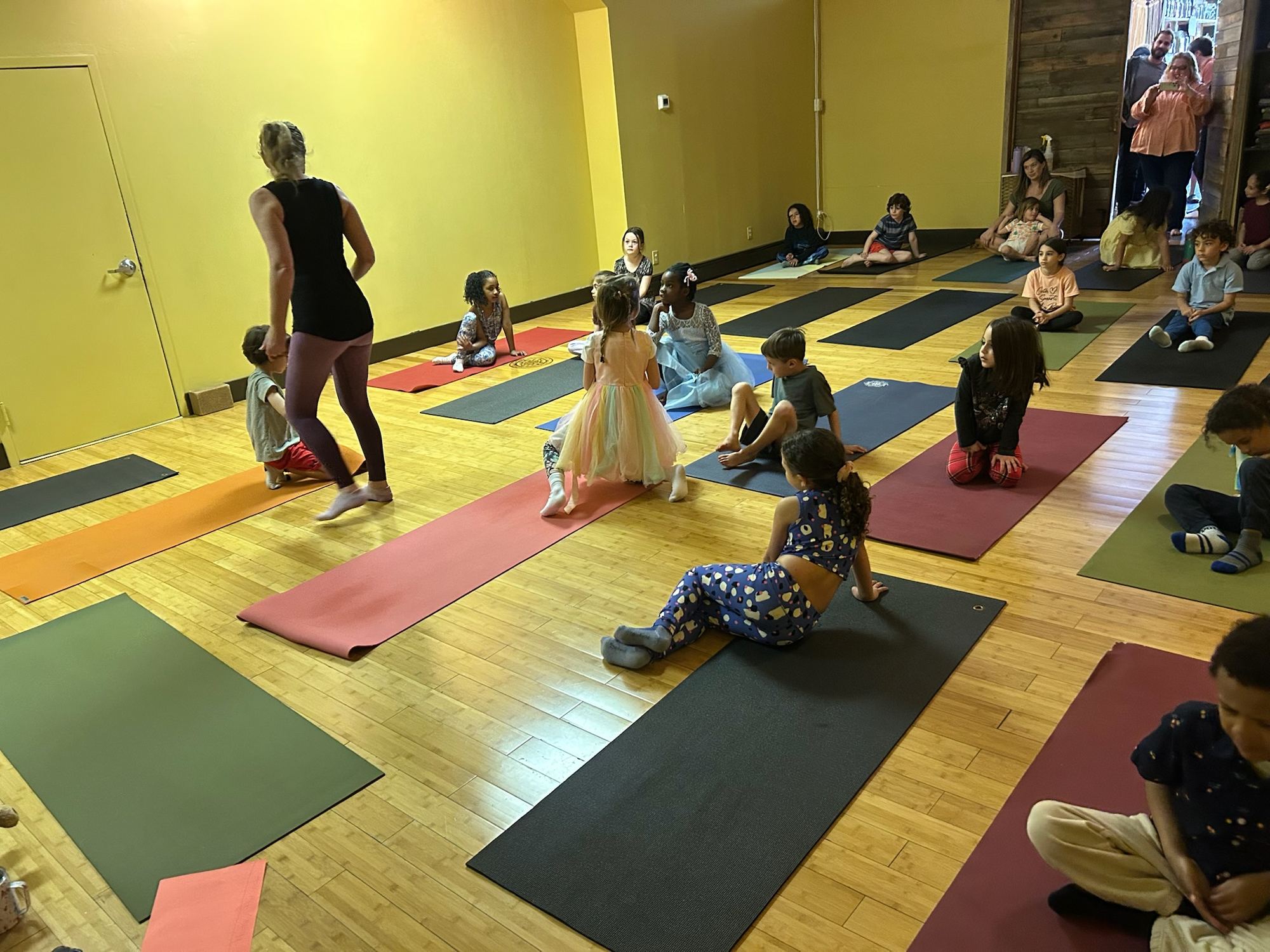 Children moving through poses at a yoga birthday party