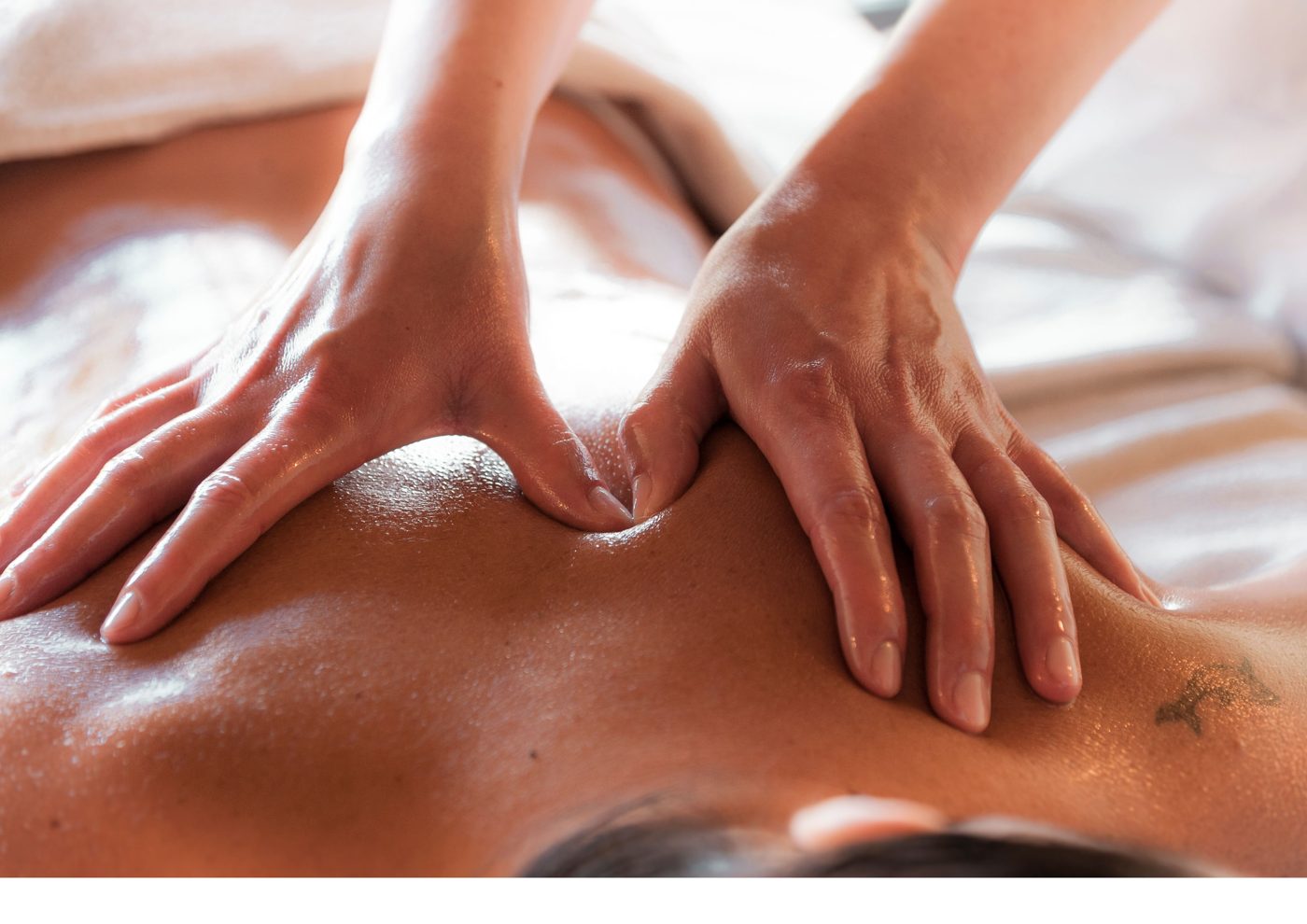 Therapeutic massage, warm oil, hands in motion