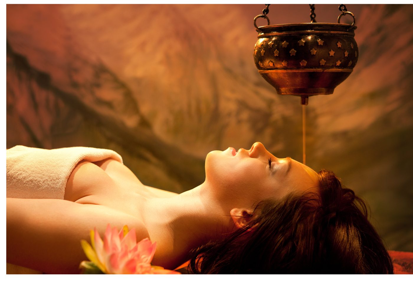 Shirodhara Ayurvedic treatment with warm oil streaming onto the forehead