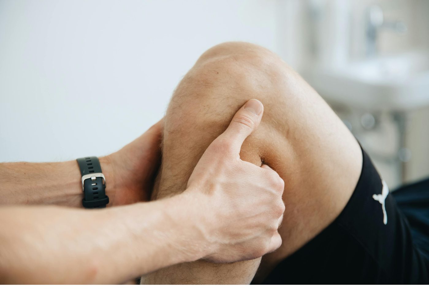 Assisted mobility work on the knee during a recovery bodywork session