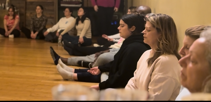 Meditation teacher training students seated in meditation