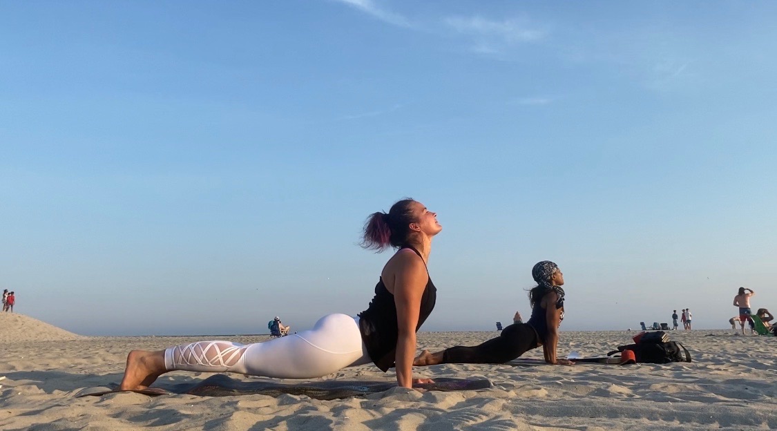 Upward-facing dog on the beach