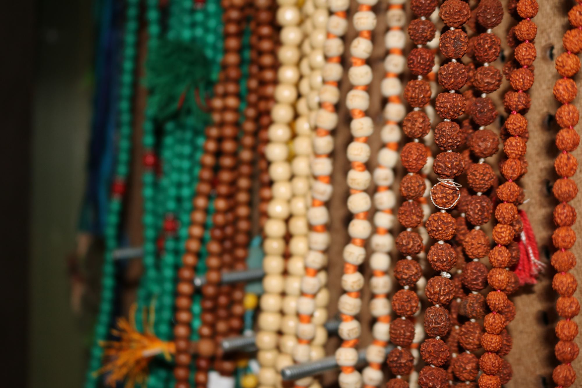 Mala bead necklaces hanging in the Revolution Yoga shop