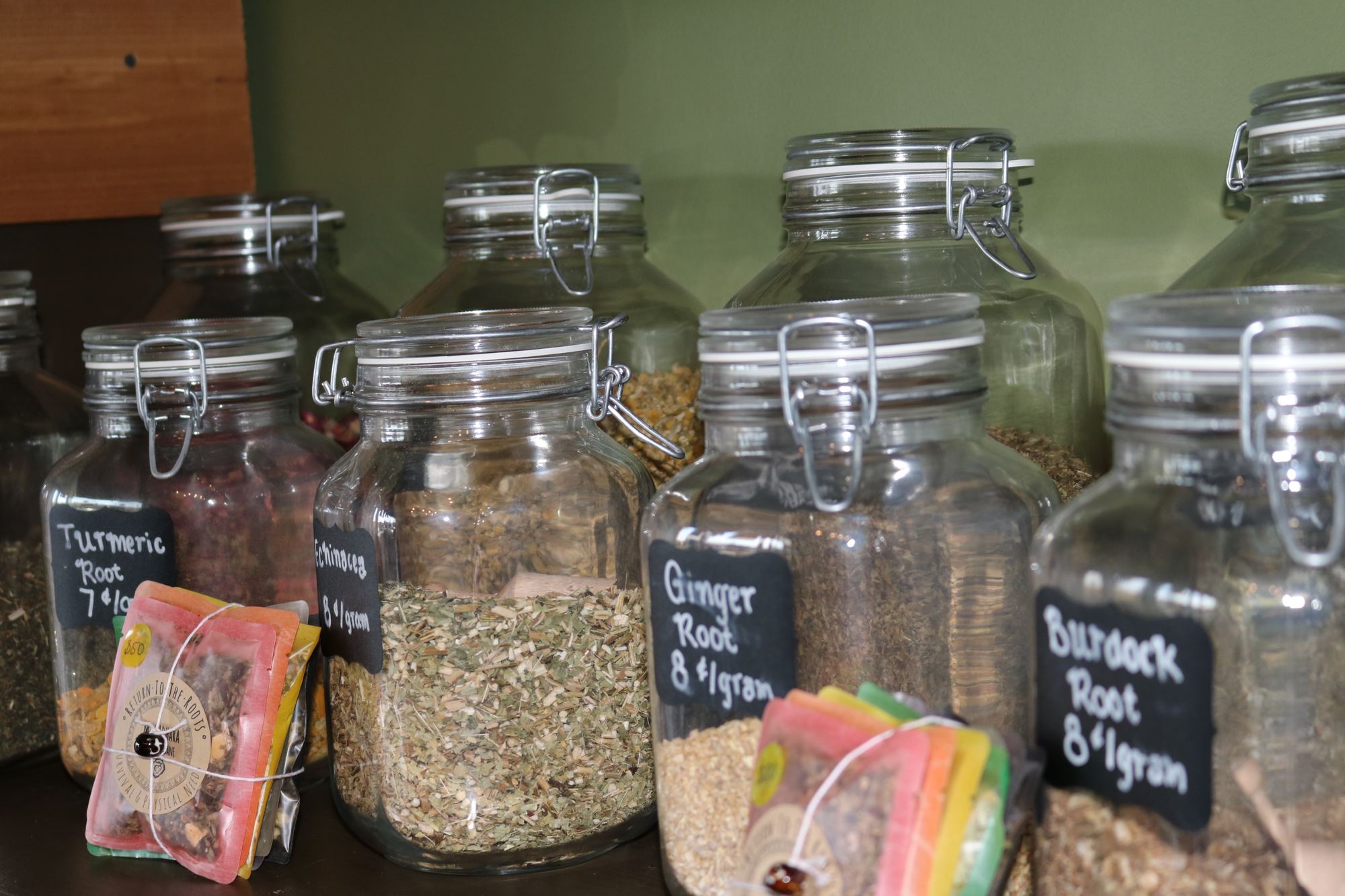 Glass jars of loose organic herbs with chalkboard labels
