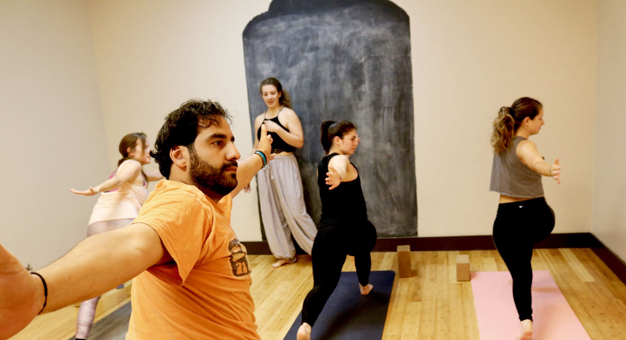 Mixed-level class, students at different stages of pose