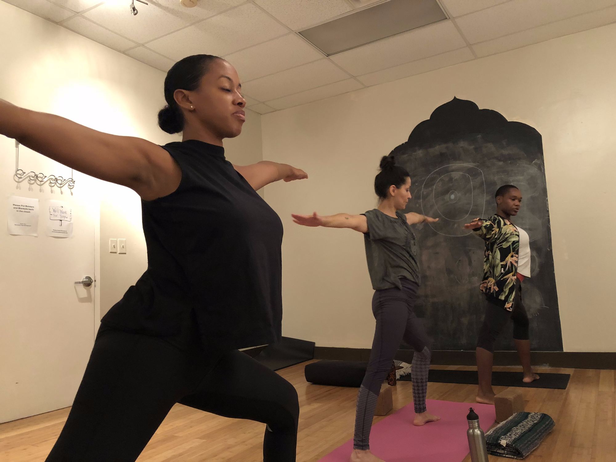 200-hour yoga teacher training students in warrior II