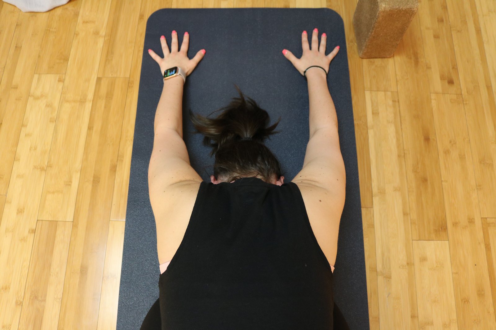Practitioner resting in a long-held yin posture on the mat