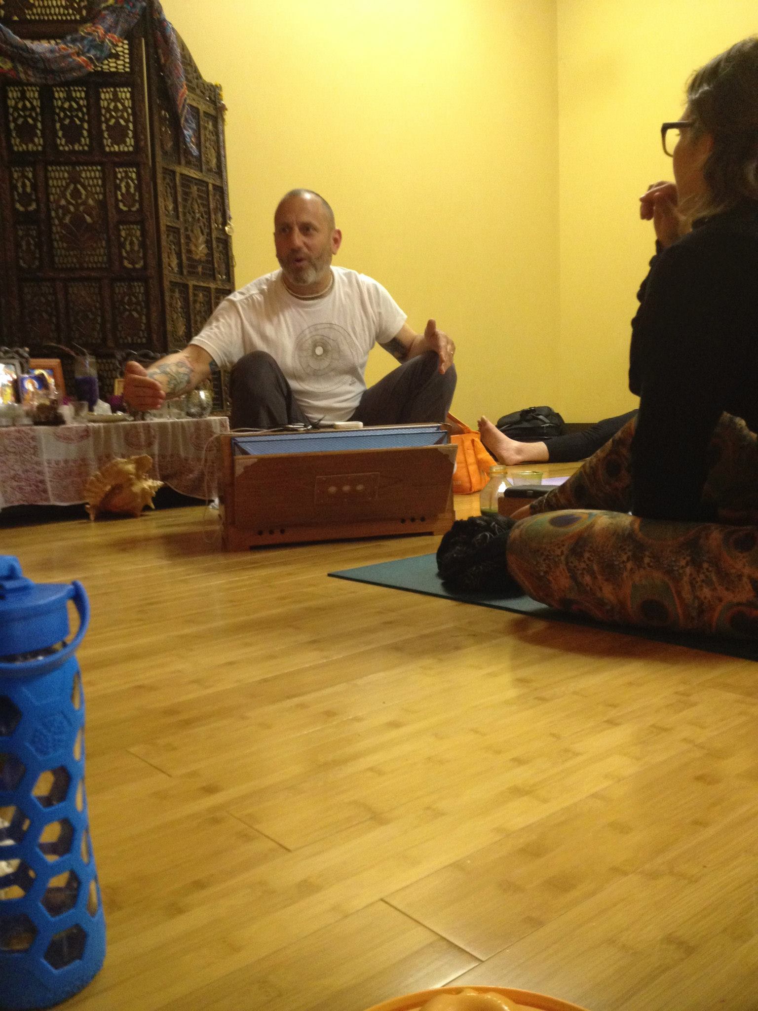 Raghu with harmonium teaching at Revolution Yoga