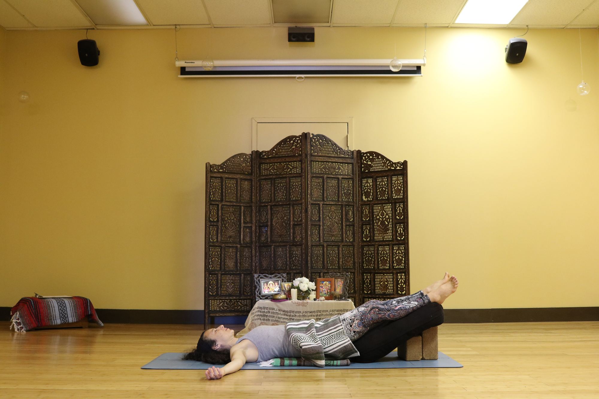 Restorative private session with a student in a supported reclined pose