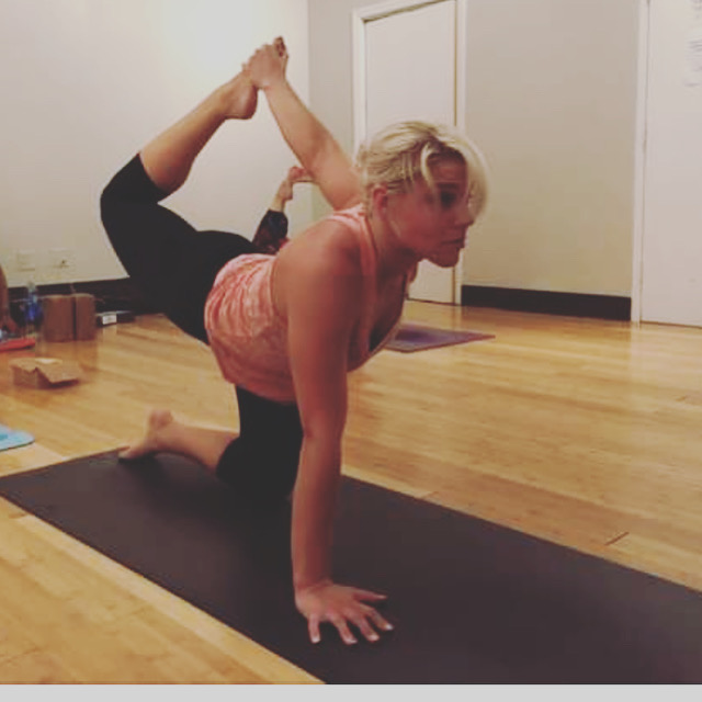 Student in a low lunge quad stretch during a private yoga class
