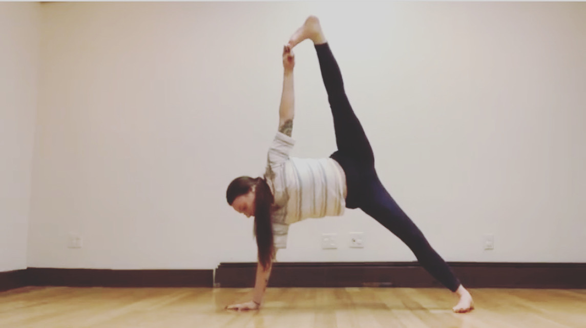 Student in a standing split, private yoga instruction