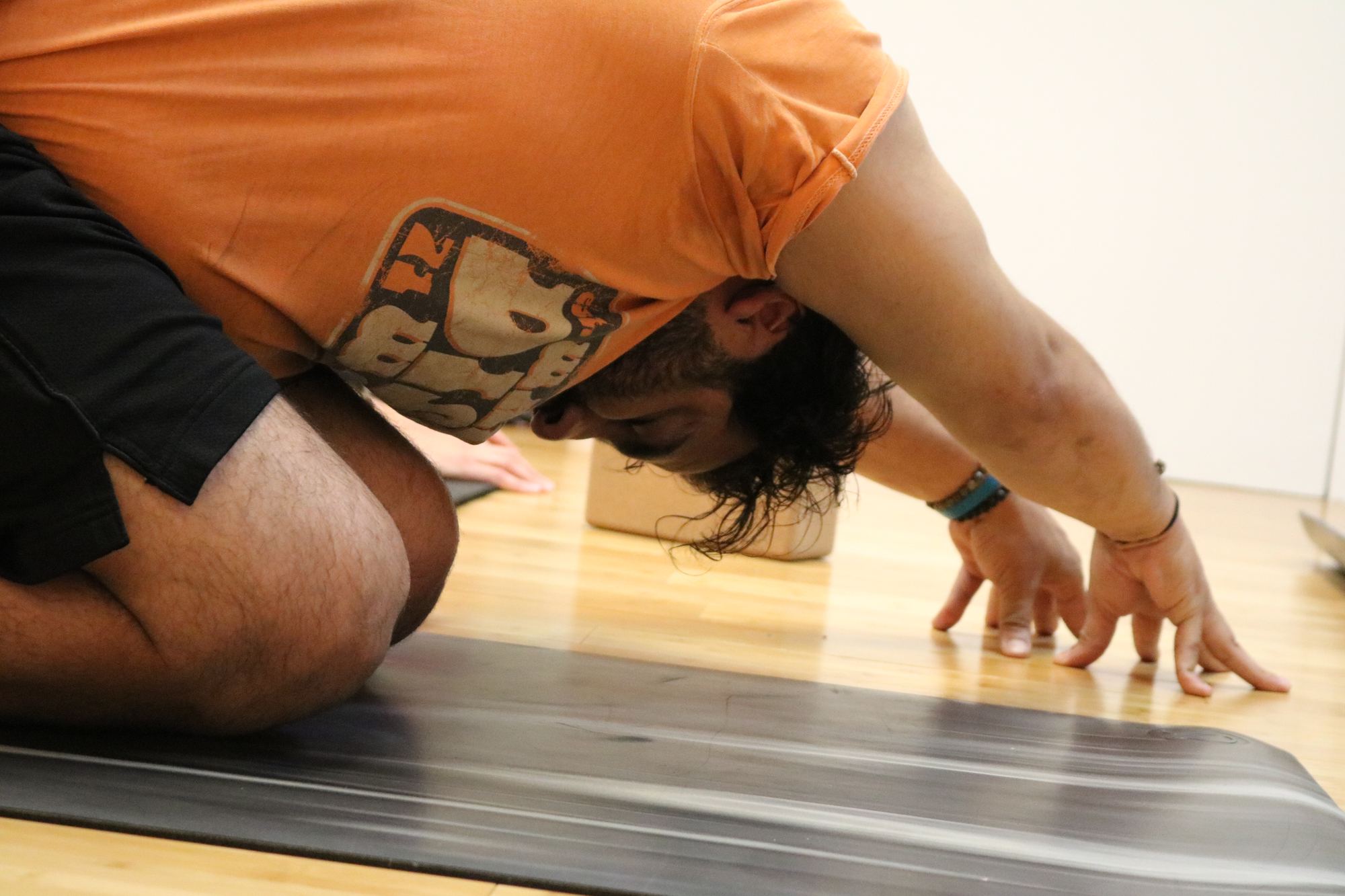 Student in a deep hip-opening frog pose