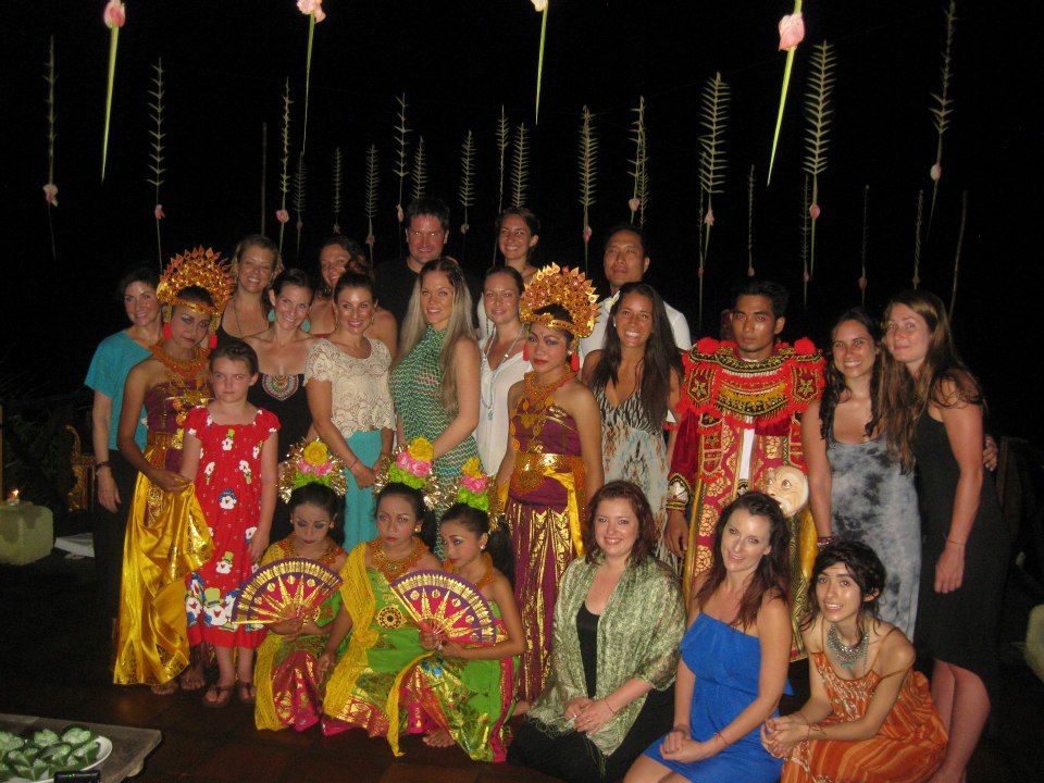 Retreat group posing with Balinese dancers at an evening ceremony