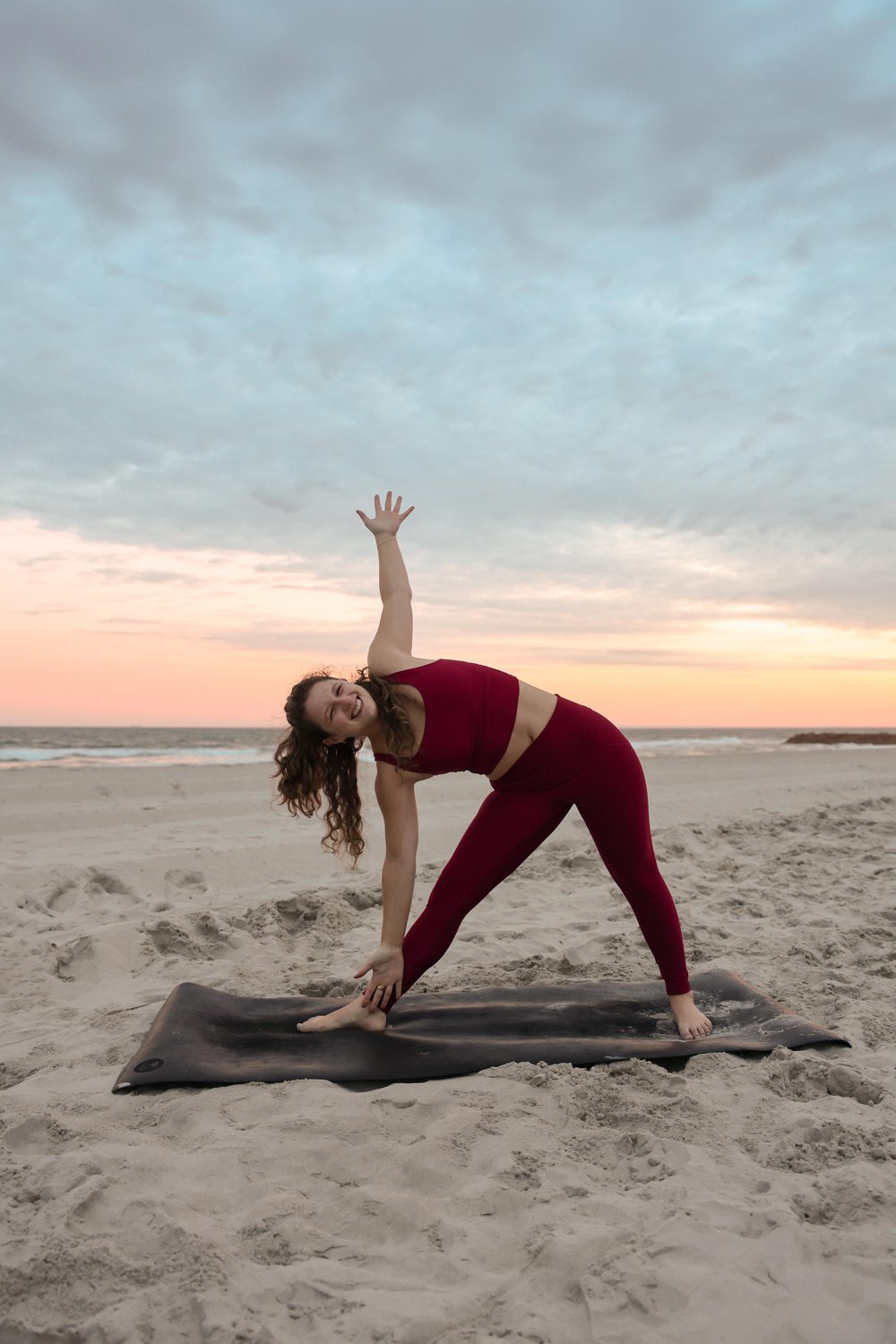 Alyssa in triangle pose on the beach at sunset