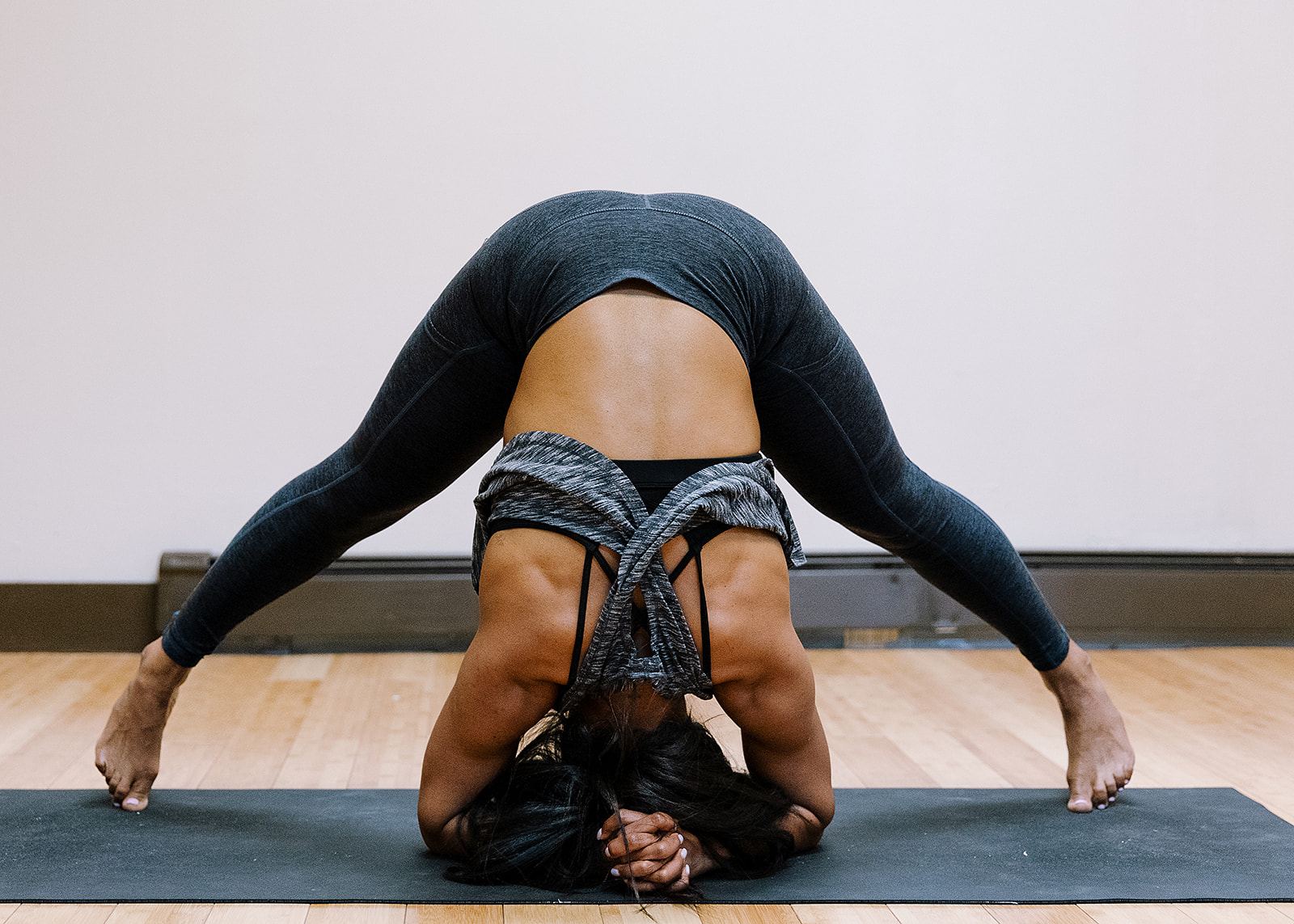 Jen Myers in a wide-legged forward fold