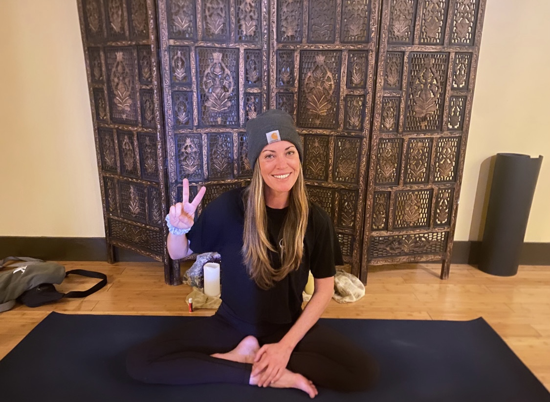 Jodi Langevin seated on her mat, smiling