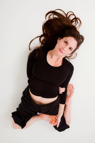 Lisa Ries seated on the floor, relaxed