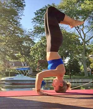 Michelle Levitsky in headstand on a dock