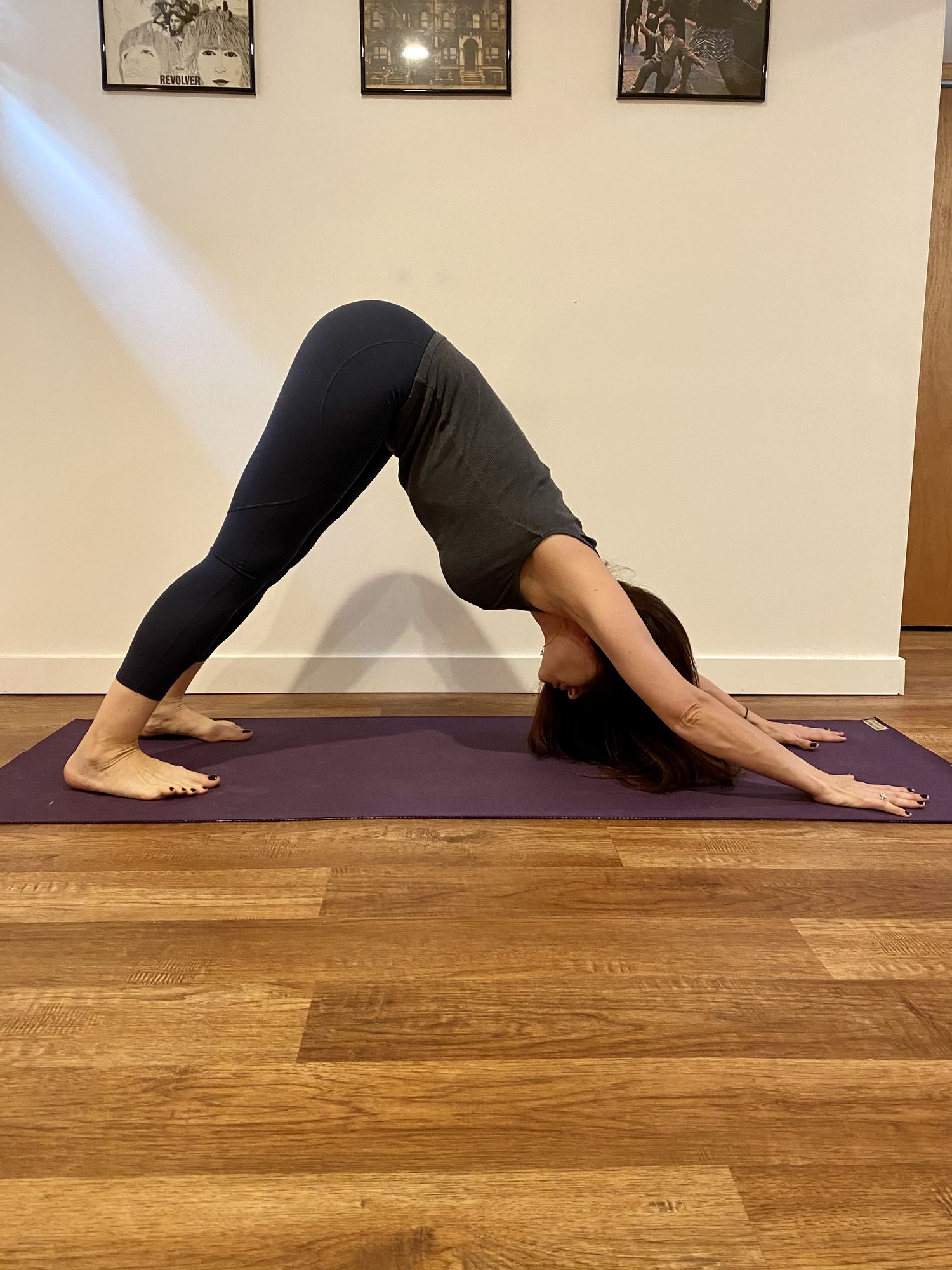 Paola Luna in downward dog at home
