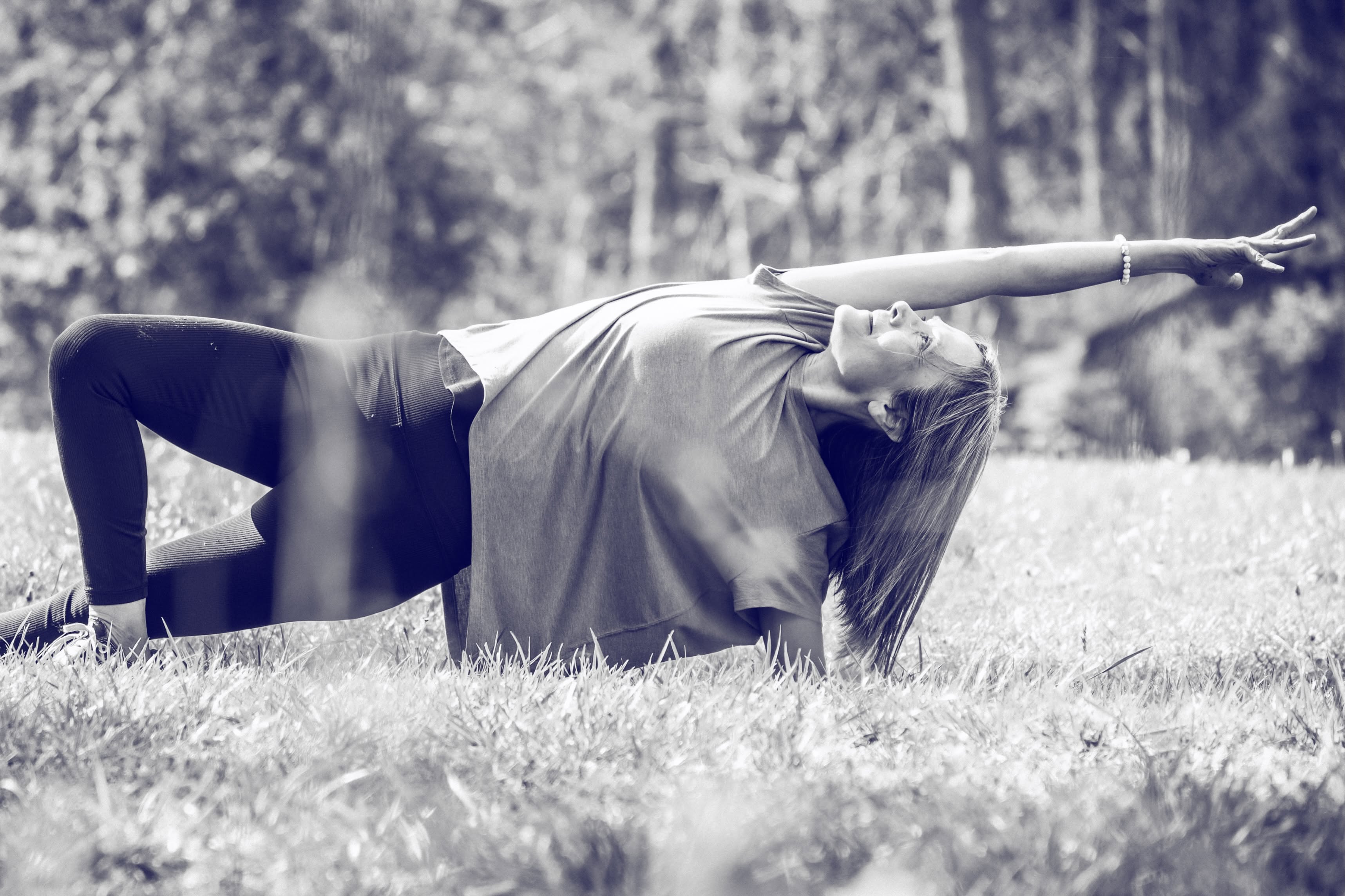 Sylvia Ehrhart in a side plank variation on the grass